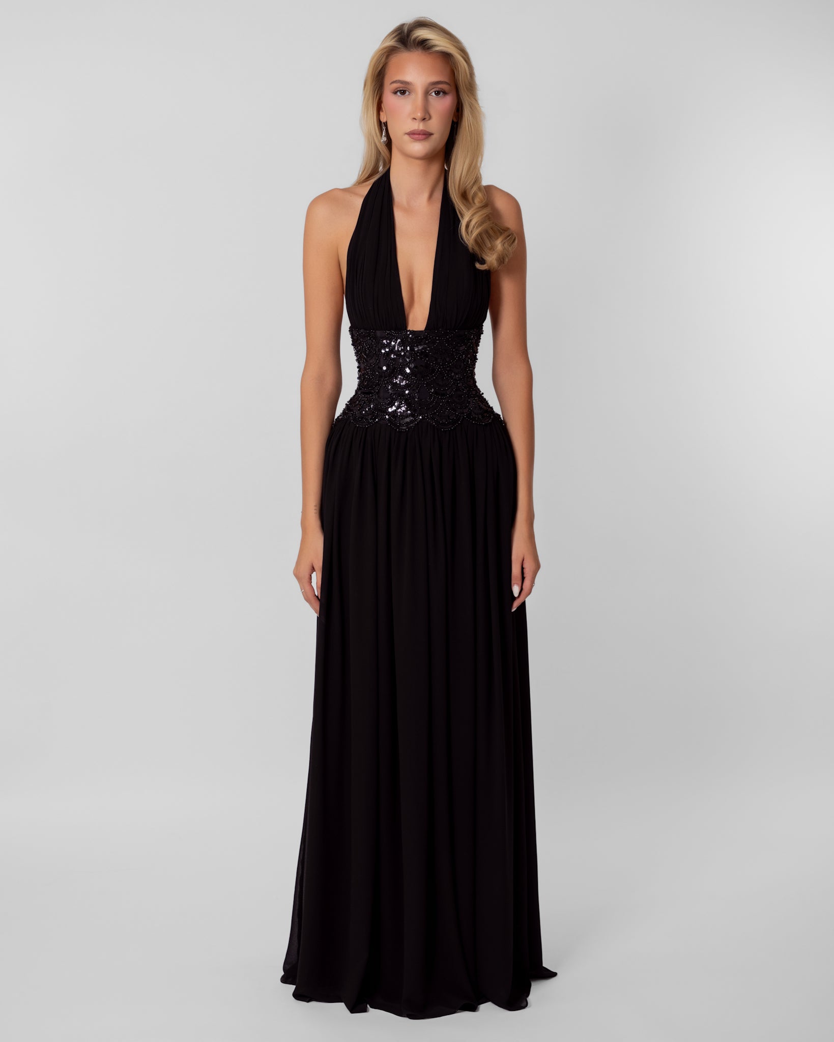Nicole Dress in Black – halter evening gown with plunging neckline, sequin-embellished corset waist, and flowing maxi skirt.